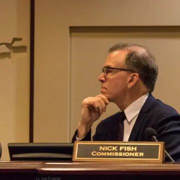 Commissioner Nick Fish intently listening at a Portland City Council meeting.
