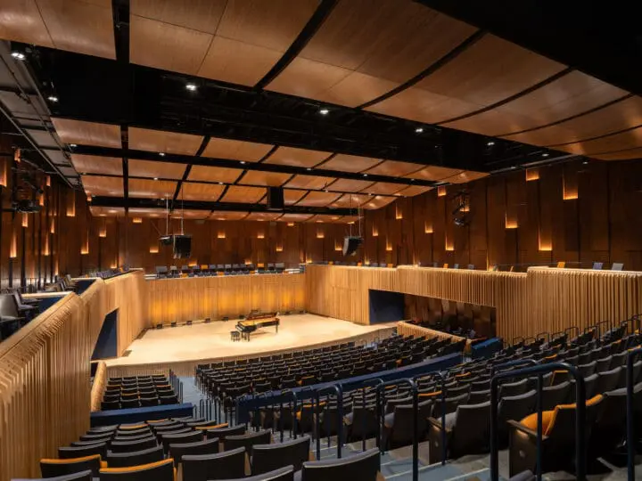 A view from the back of PRAx’s large recital hall, looking down at the seats and stage.